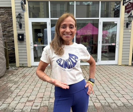 Rosie, a yoga instructor from Florida, standing peacefully at the Berkshire Yoga Festival wearing Umindak activewear, embodying the meaning of “Eunoia” (a well‑balanced mind) in a sunlit outdoor yoga pose.